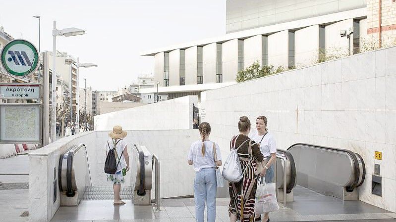 Touristen stehen an der geschlossenen Metro-Station an der Akropolis in Athen. Foto: Socrates Baltagiannis/dpa