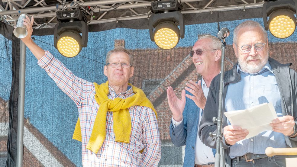 Er leerte den Humpen in einem Zug: Der neue „Ehrenstörtebeker“ Bernhard Schwitters mit (von links) IG-Chef Manfred Kruse und Marienhafes Bürgermeister Johann Tjaden bei der Eröffnung. Foto: Folkert Bents