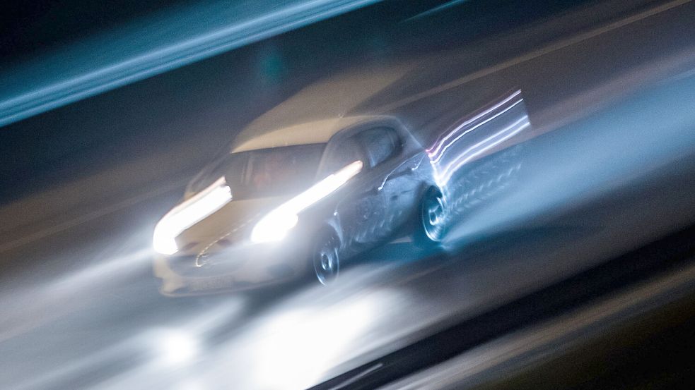 Ein Auto fährt bei Nacht. Der Bewegungseffekt entstand durch Langzeitbelichtung und Mitziehen. Foto: DPA