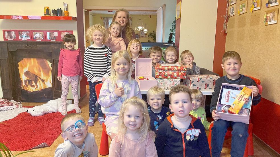 Stolz präsentiert Jessica Rohlfs gemeinsam mit Kindern einen Teil der bereits abgelieferten Geschenkeboxen. Foto: Holger Janssen