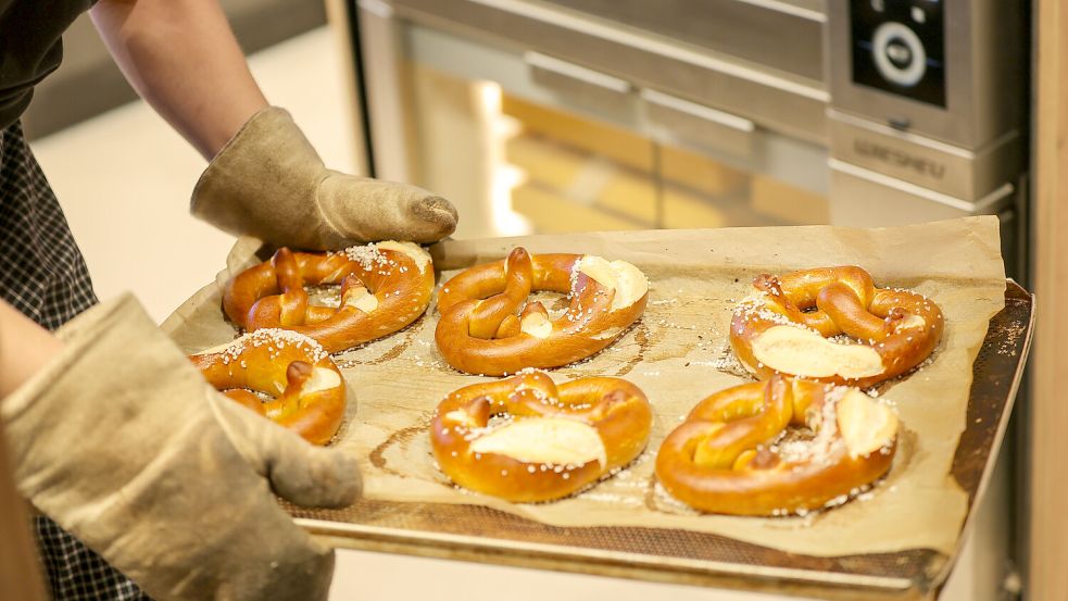 Ein Blech mit Brezeln wird aus einem Backofen genommen. Bäckereien gehören zu den Branchen, die es bei der Nachwuchssuche besonders schwer haben. Foto: DPA