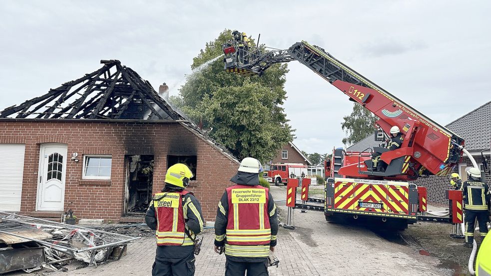 Wieder auflodernde Flammen machten am Brandort in Osteel Nachlöscharbeiten erforderlich. Zur Unterstützung wurde Norder Drehleiter gerufen. Foto: Feuerwehr