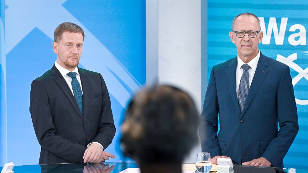 Der amtierende Ministerpräsident Michael Kretschmer (CDU) und AfD-Spitzenkandidat Jörg Urban: Beide Parteien bekommen einen Sitz weniger, als zunächst angegeben. Foto: dpa/Robert Michael