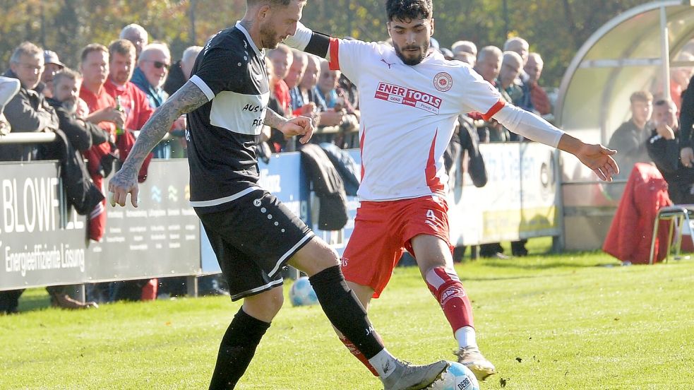 Der Wiesmoorer Jürgen Zimmermann im Duell mit dem Fehntjer Mahmud Tamoyan. Foto: Bernd Wolfenberg