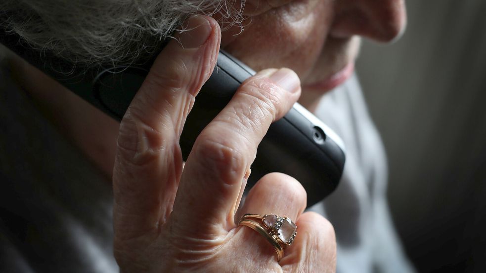 Eine ältere Frau telefoniert. Die Polizei warnt vor einer Betrugsmasche per Telefon. Foto: DPA